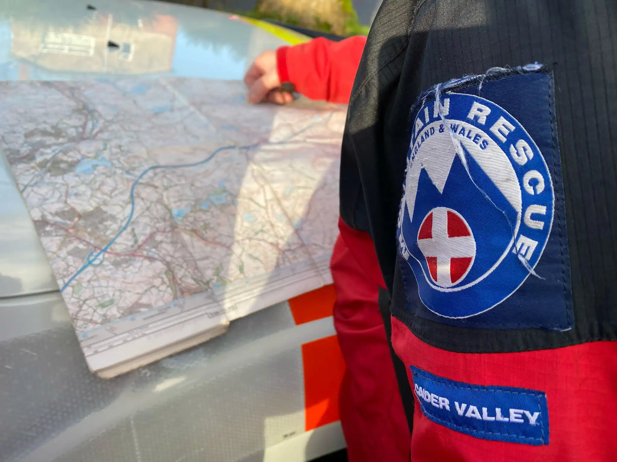 A team member looking at a map to plan a search.